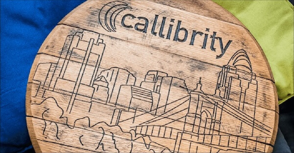 A wooden board with ‘Callibrity’ across the top, the body of the board is an engraving of the Cincinnati Skyline